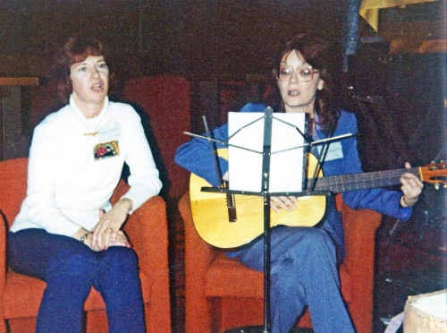 D.C. Fontana and Lynn Barker sing filk at a convention.